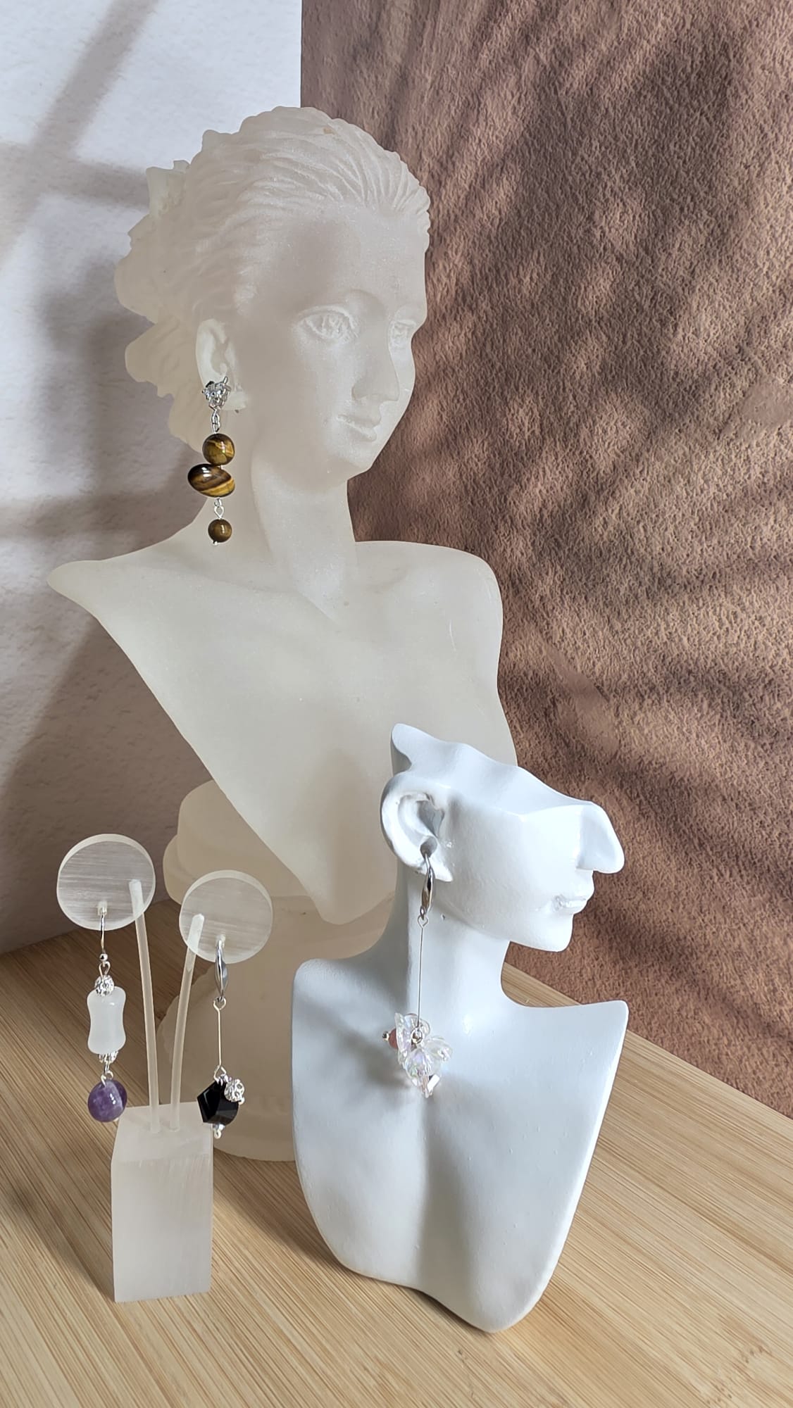 Finished pieces on display — hand-threaded earrings and bracelets